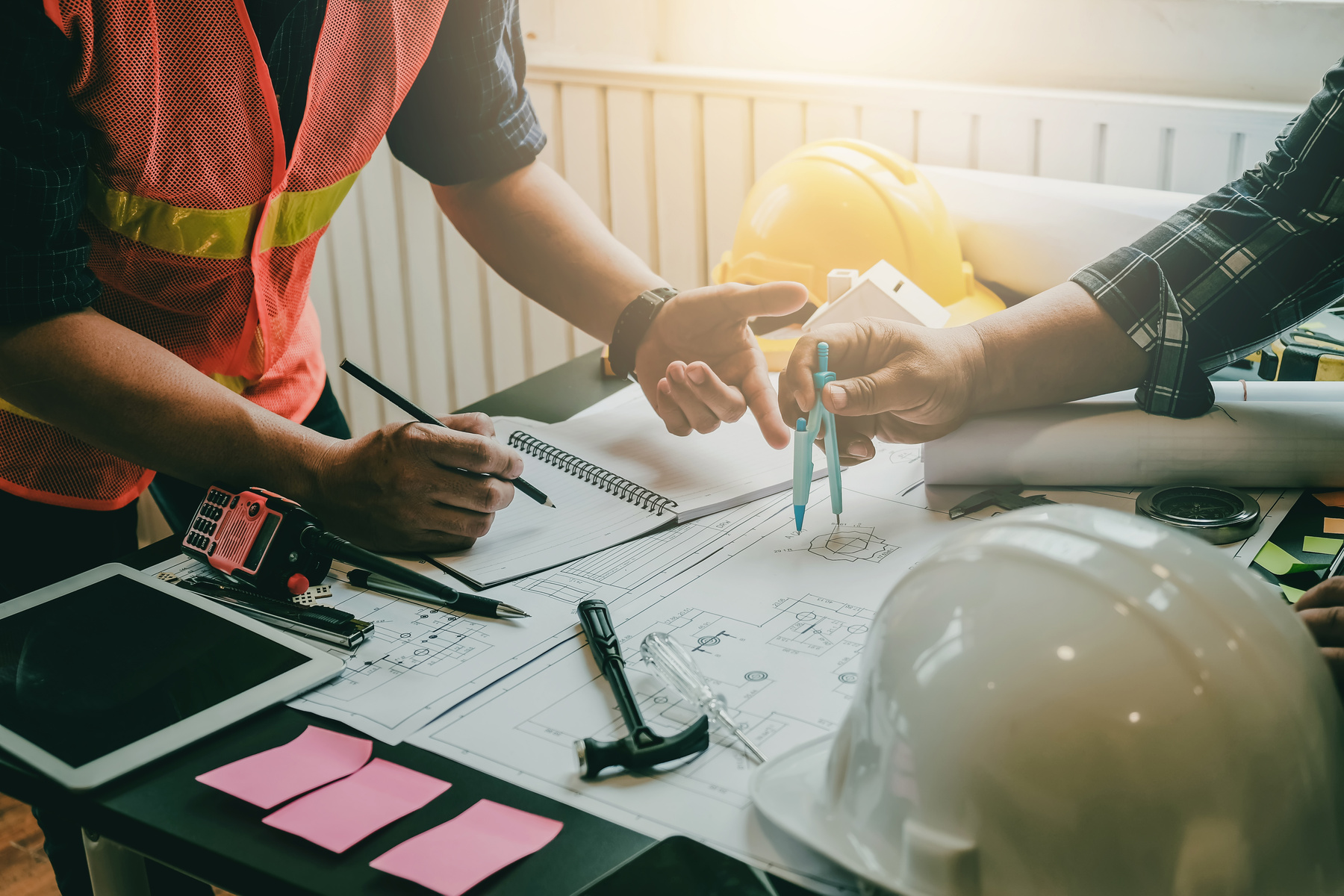 Construction project owner and engineer planning and meeting construction plan together.